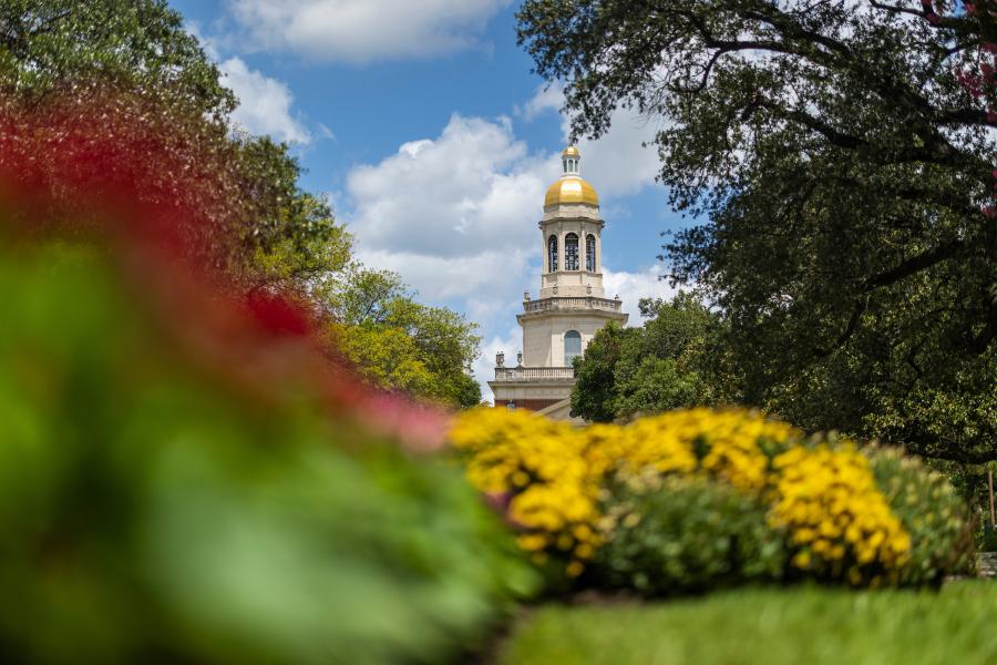 Pat Neff pictured from low on Founders Mall and flanked by trees and flowers